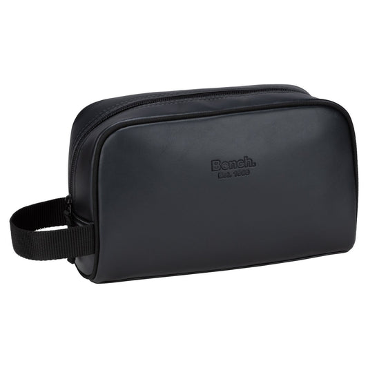 Product Image – The Bench Jayce Toiletry Bag is black faux leather with a side handle and "Bench. Est. 1989" on the front.