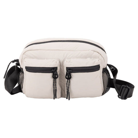 Product Image – Bench Nylon Crossbody: beige nylon bag with two front zip pockets, black zippers, and adjustable strap.