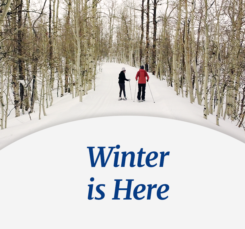 Couple in snow shoes exploring a winter snowy trail - Winter is Here