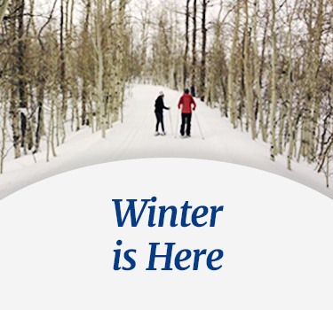 Couple in snow shoes exploring a winter snowy trail - Winter is Here