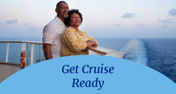 A couple standing on the back deck of a cruise ship, looking into the distance. Get Cruise Ready text is displayed on top on a blue oval shape on the foreground of the picture.