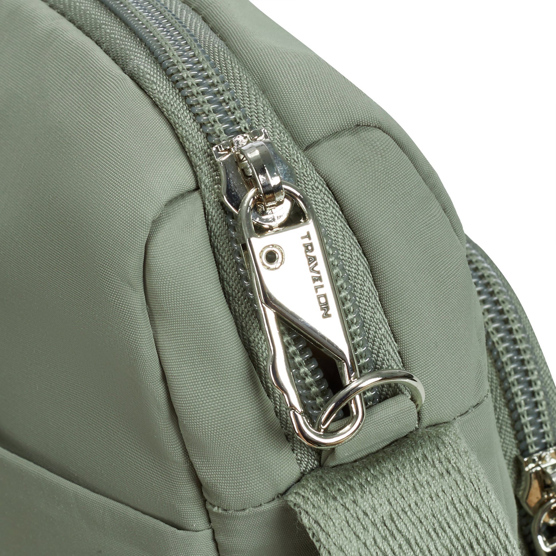 Close up of locking zipper pull on moss Travelon Roam Anti-theft East/West Crossbody.