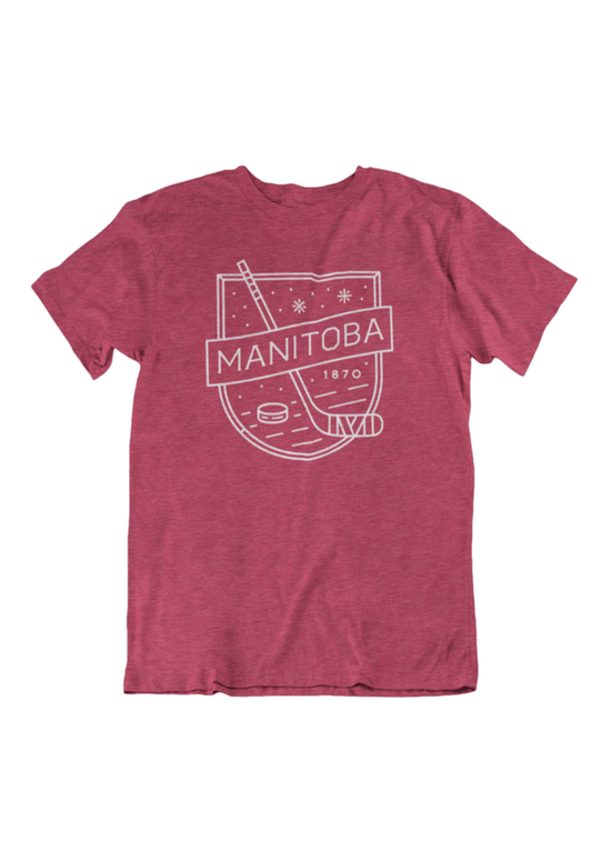 Product Image – Heather Cardinal Red T-shirt from We Heart Winnipeg, showcasing a white graphic design that includes "Manitoba 1870" along with a hockey stick and puck illustration—a must-have for any puck lover's wardrobe. Product Name: We Heart Winnipeg MB Hockey T-Shirt.