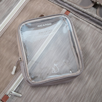 A clear pouch labeled "RICARDO" rests on a Ricardo Beverly Hills Montecito 3.0 Softside Carry-on lining.