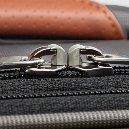 Close-up of two silver zipper pulls on the Ricardo Beverly Hills Montecito 3.0 Softside Carry-on Spinner.