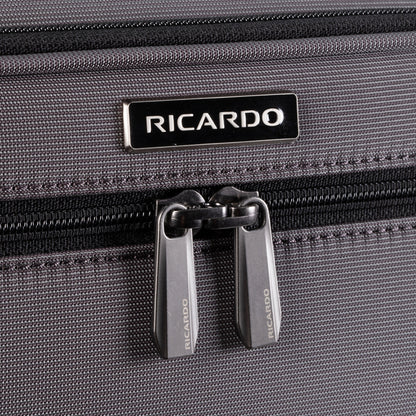 Close-up of Ricardo Beverly Hills Montecito 3.0 Softside Carry-on Spinner in gray with double zippers and logo above.
