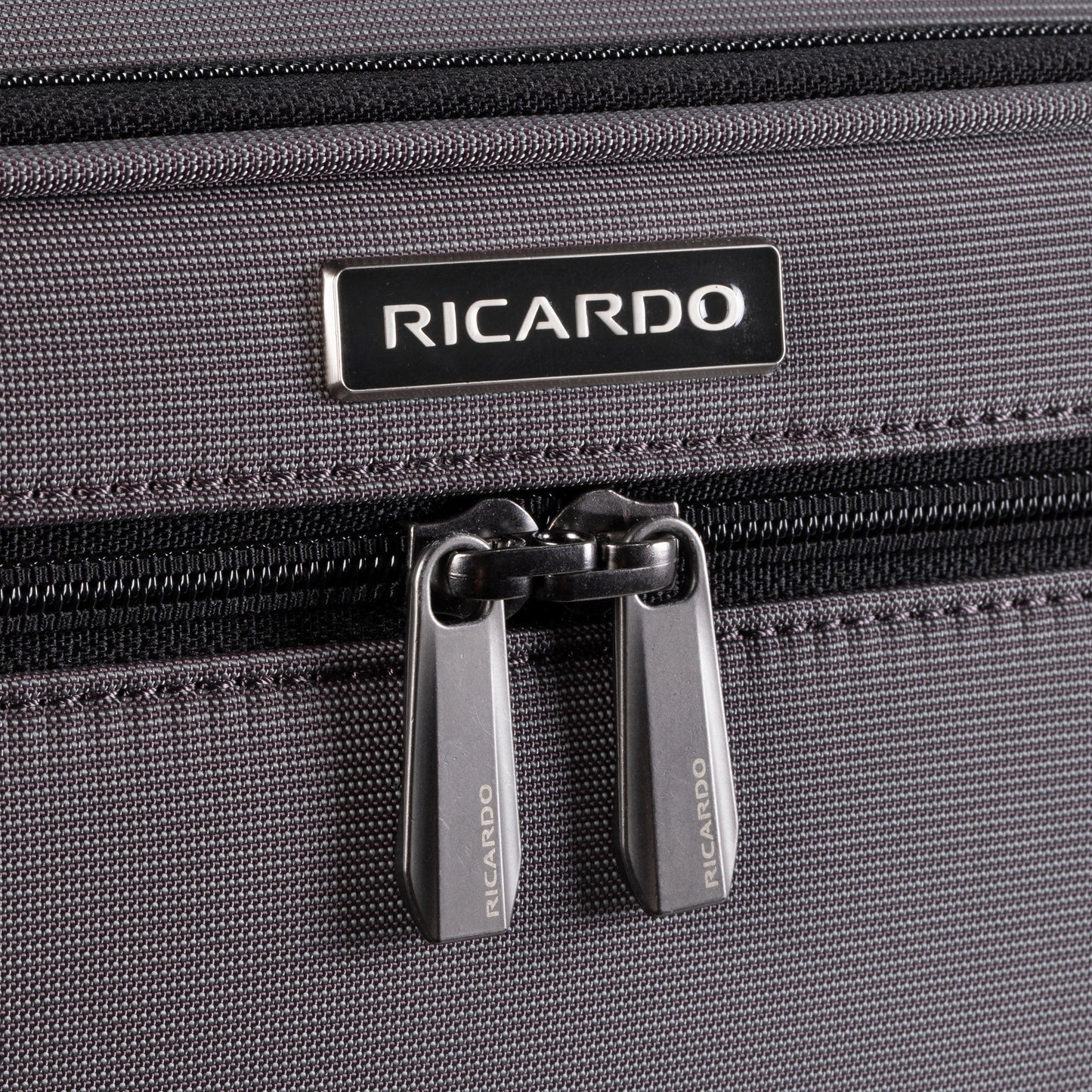 Close-up of the Ricardo Beverly Hills Montecito 3.0 medium softside spinner with dual zipper pulls.