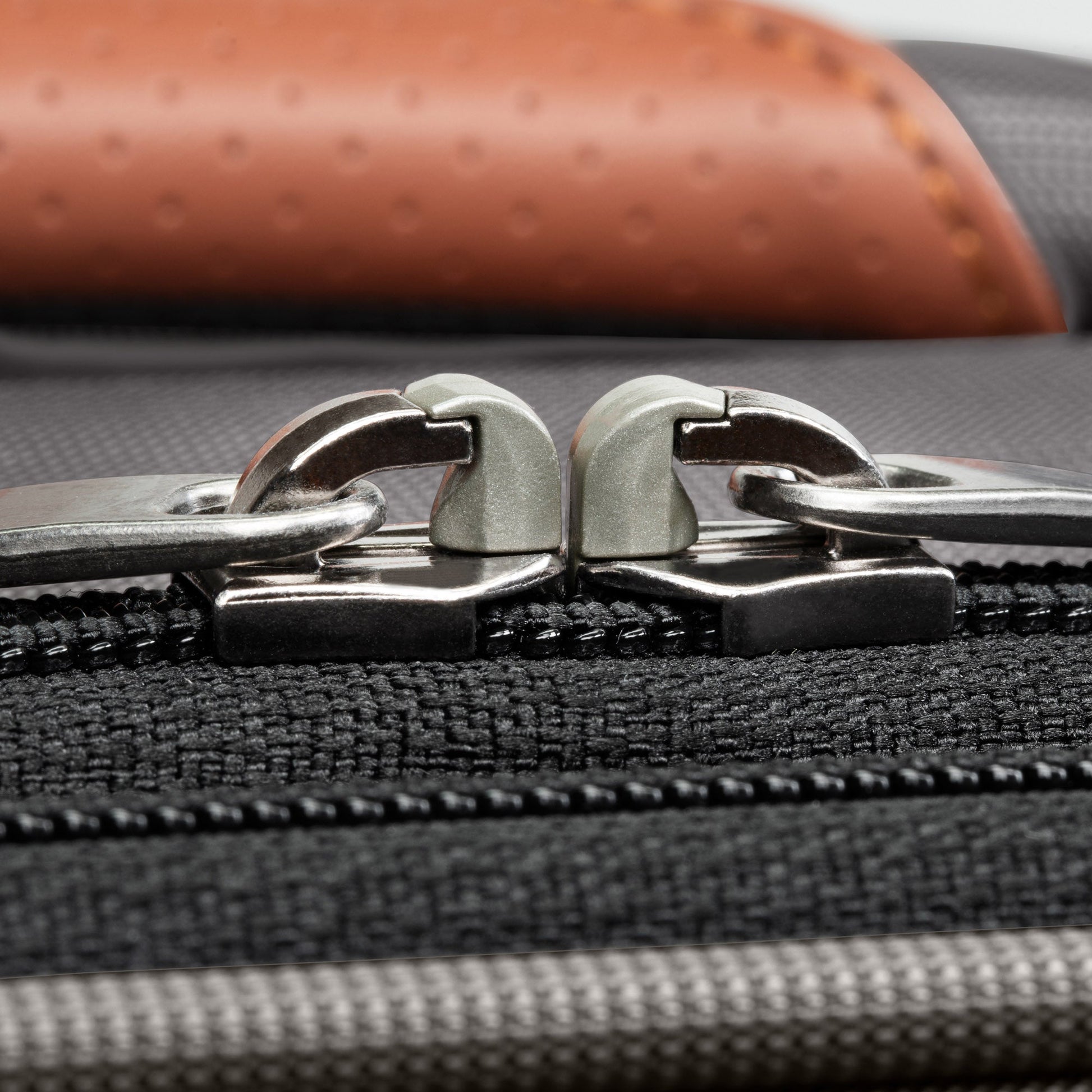 Close-up of silver zippers on the Ricardo Beverly Hills Montecito 3.0 Large Check-In Expandable Spinner.