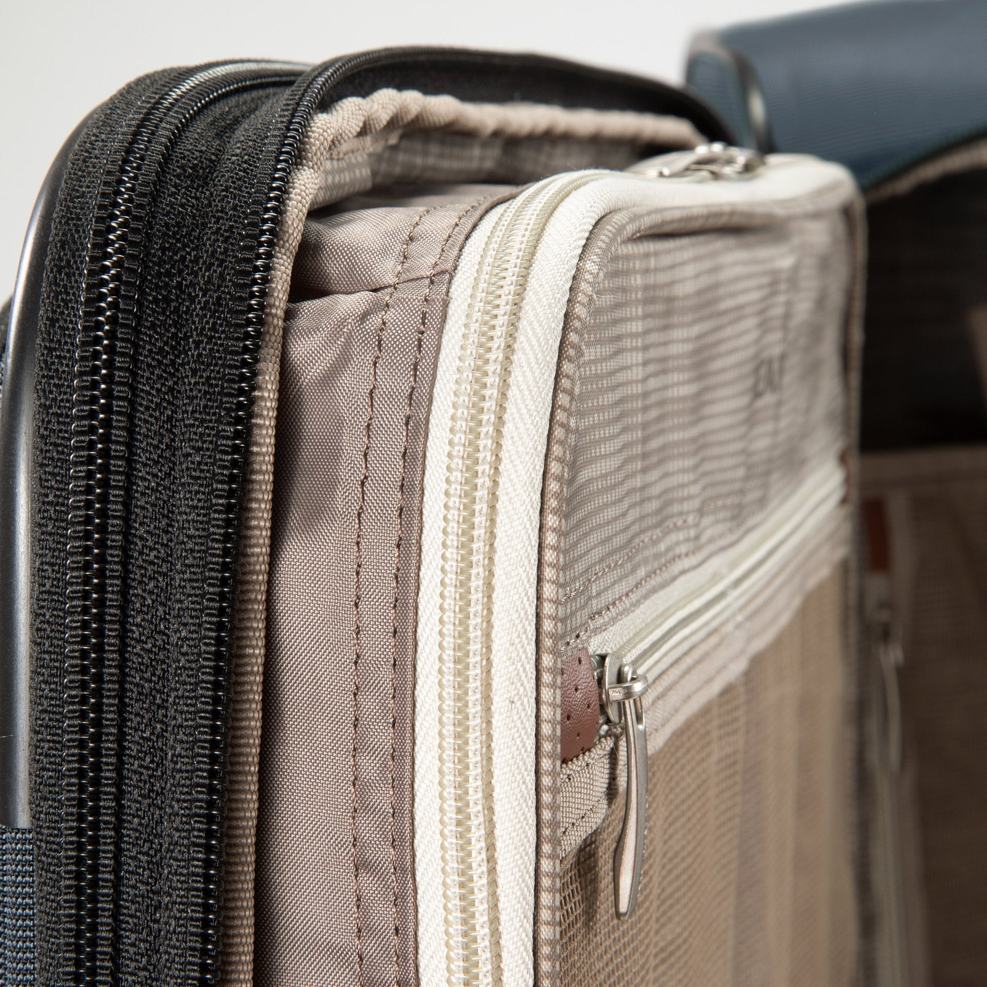 Close-up of two zippered compartments on the Ricardo Beverly Hills Montecito 3.0 Softside Large Spinner suitcase.