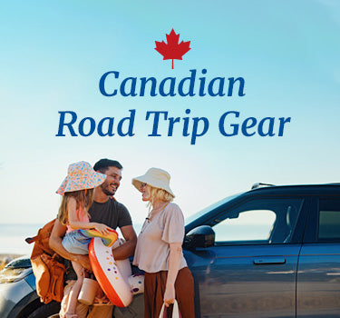 Canadian Road Trip Gear - family parked by a beach, standing on the side of a car ready to go.