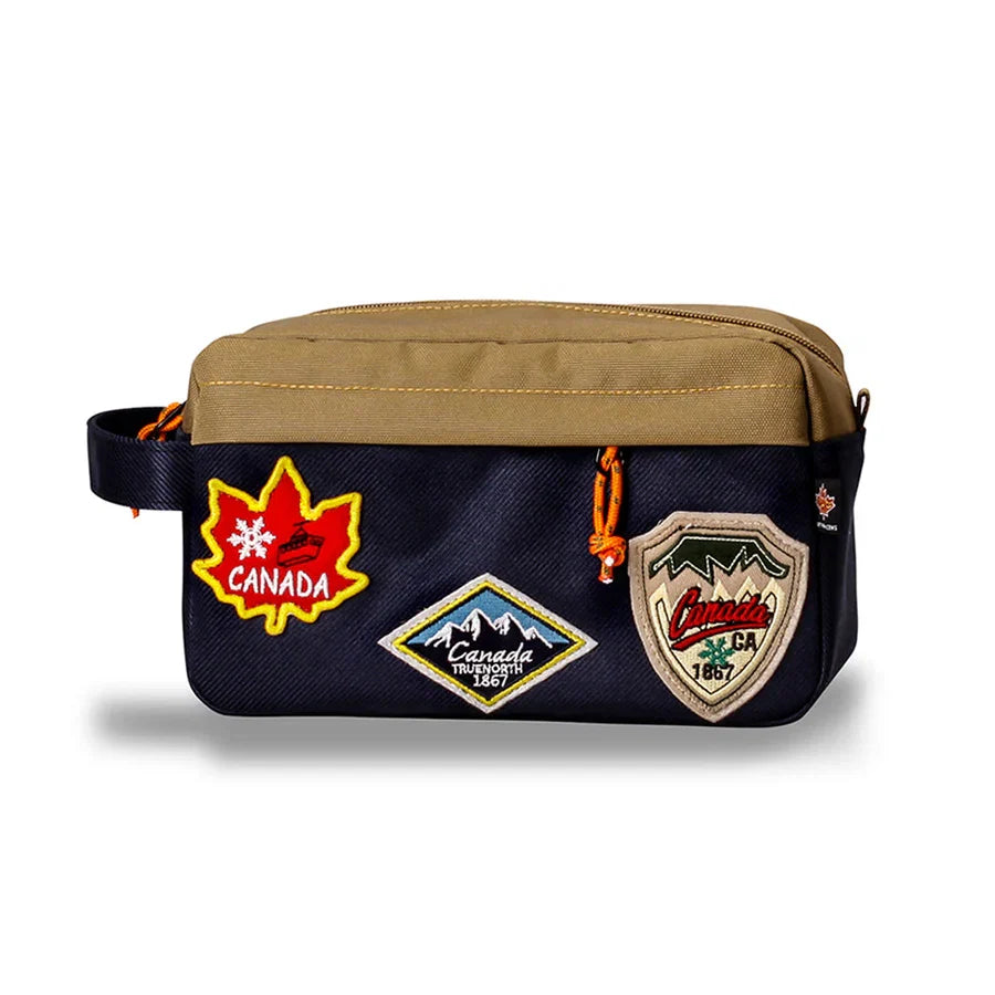 Northern Icons Canada Travel Toiletry Bag with brown top, navy bottom, side handle, and Canada patches.