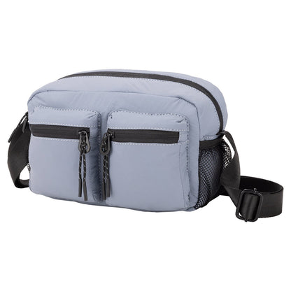 Bench Nylon Crossbody: Light blue bag with two zip pockets, mesh side pocket, and adjustable black strap.