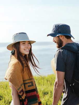 Man and Woman in tshirts and hats - See All Clothing products