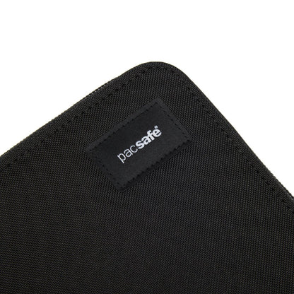 Close-up of black Pacsafe® RFIDsafe™ logo label on a recycled polyester travel organizer.