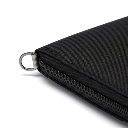 Close-up of a Pacsafe® RFIDsafe™ Travel Organizer corner with metal ring on a white background.