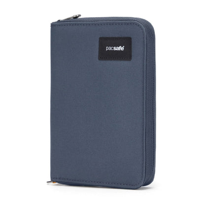 A blue Pacsafe RFIDsafe travel organizer, upright with a black logo patch.