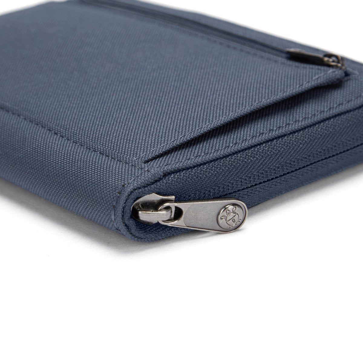 Close-up of a Pacsafe RFIDsafe blue travel organizer with RFID blocking and visible zipper.