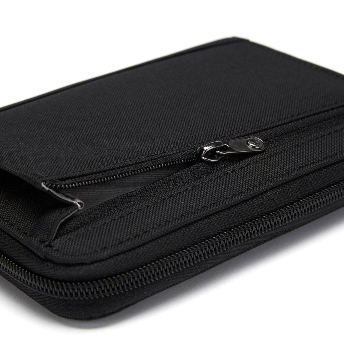Close-up of partially opened Pacsafe® RFIDsafe™ Travel Organizer, showcasing its black texture and stitching.