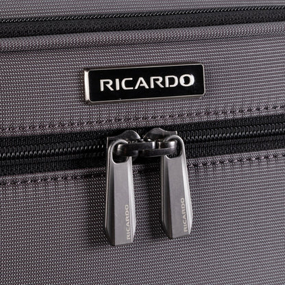 Close-up of Ricardo Beverly Hills Montecito 3.0 Softside Carry-on Spinner in gray with double zippers and logo above.