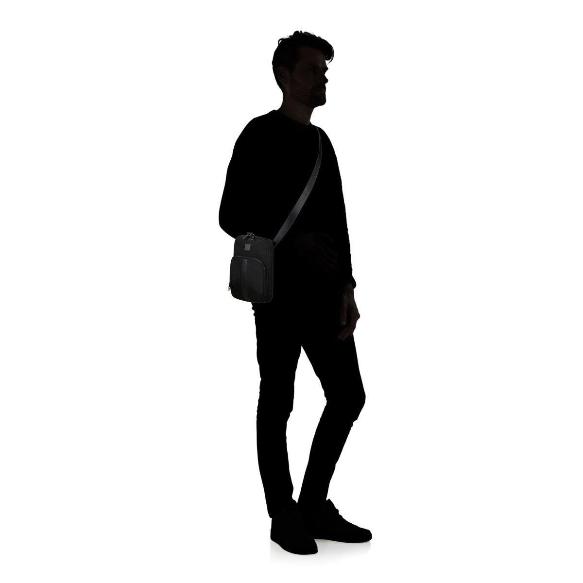 A silhouette of a person stands against a white background, highlighting the Samsonite SackSquare Crossbody Small worn for hands-free convenience.