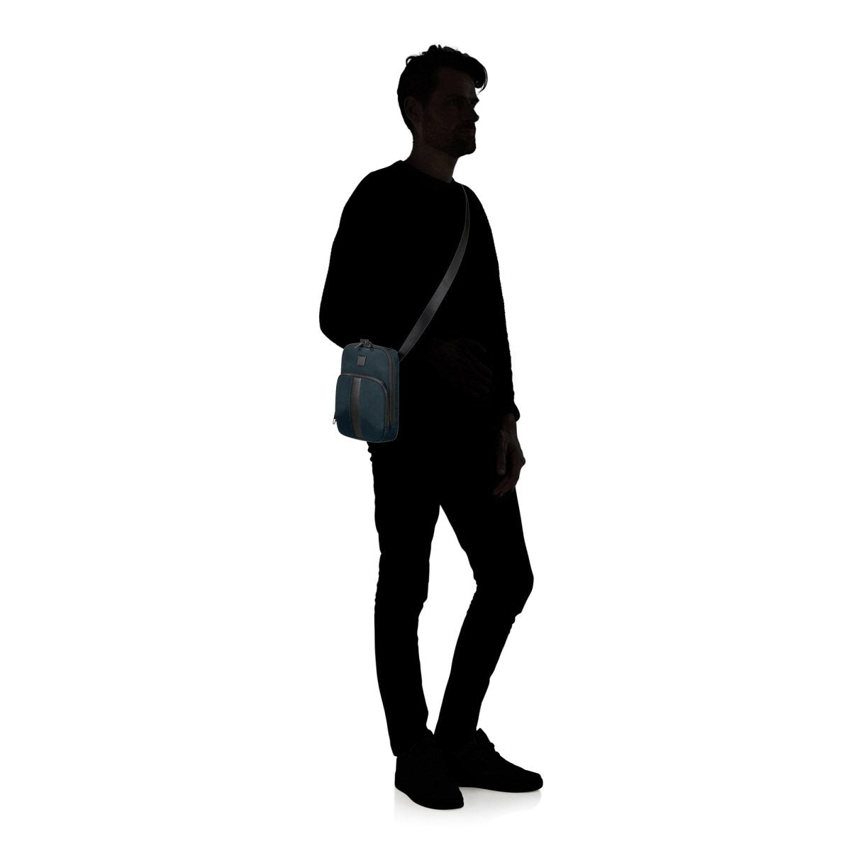 A silhouette of a person standing with the Samsonite SackSquare Crossbody Small slung over their shoulder, showcasing hands-free mobility against a white background.