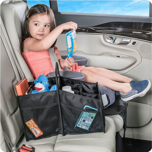 Product Image – Image showing a young girl strapped into a car seat with the product in black on the seat next to her.