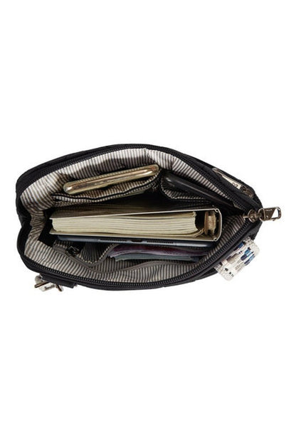 Open the Travelon Boho Anti-Theft Slim Crossbody to reveal its organized compartments, where a notebook, wallet, and various small items are securely tucked away. It also features RFID blocking technology for enhanced security.