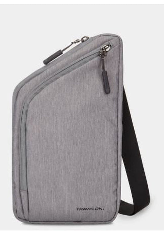 Product Image – This Travelon World Travel Essentials Slim Crossbody Bag in gray is designed with a curved zipper pocket and an adjustable black strap, featuring the "Travelon" brand name at the bottom. Enjoy peace of mind on your travels with its RFID-protected design.