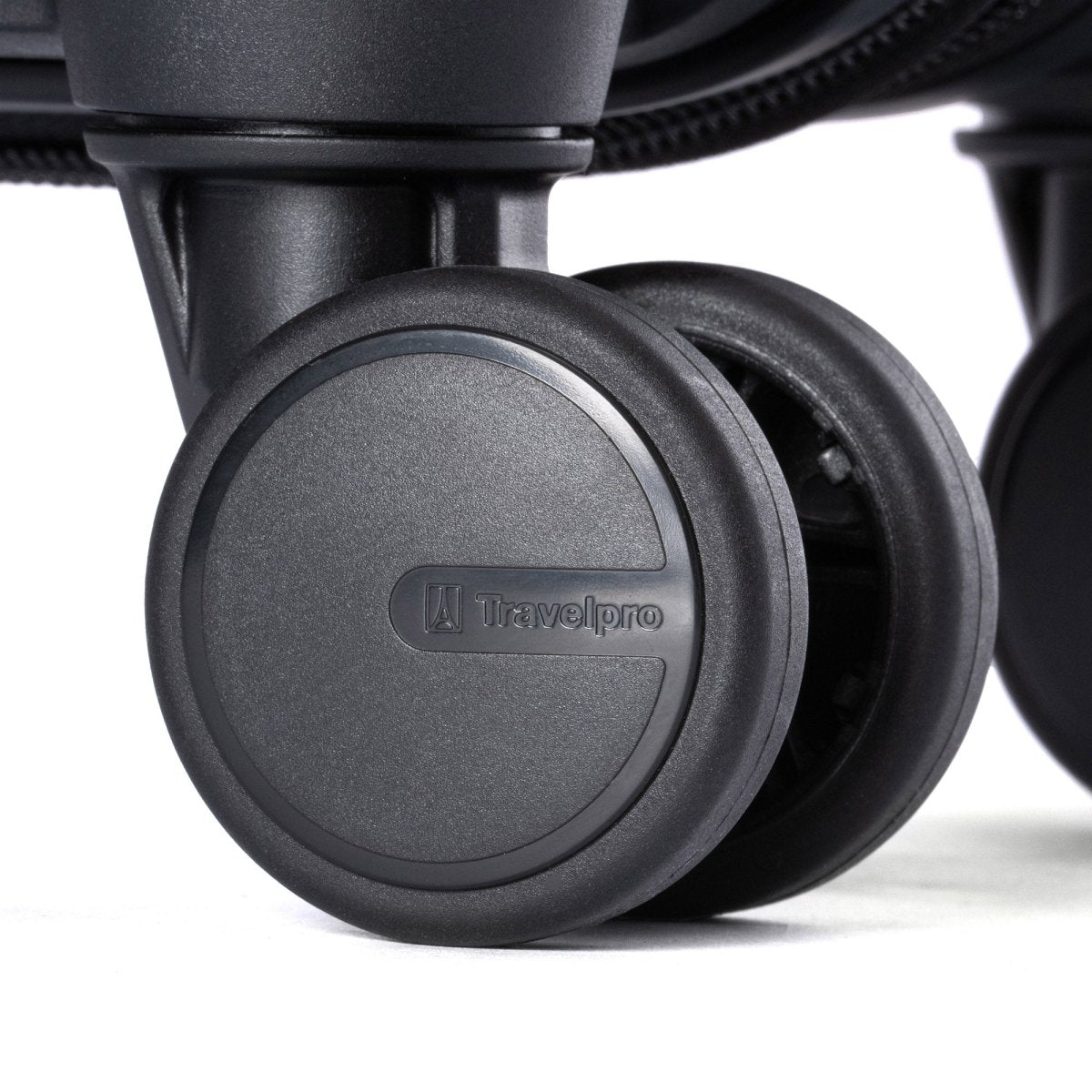 Close-up of a Travelpro® Maxlite® Air V2 Compact Carry-on Hardside Spinner wheel with logo visible.