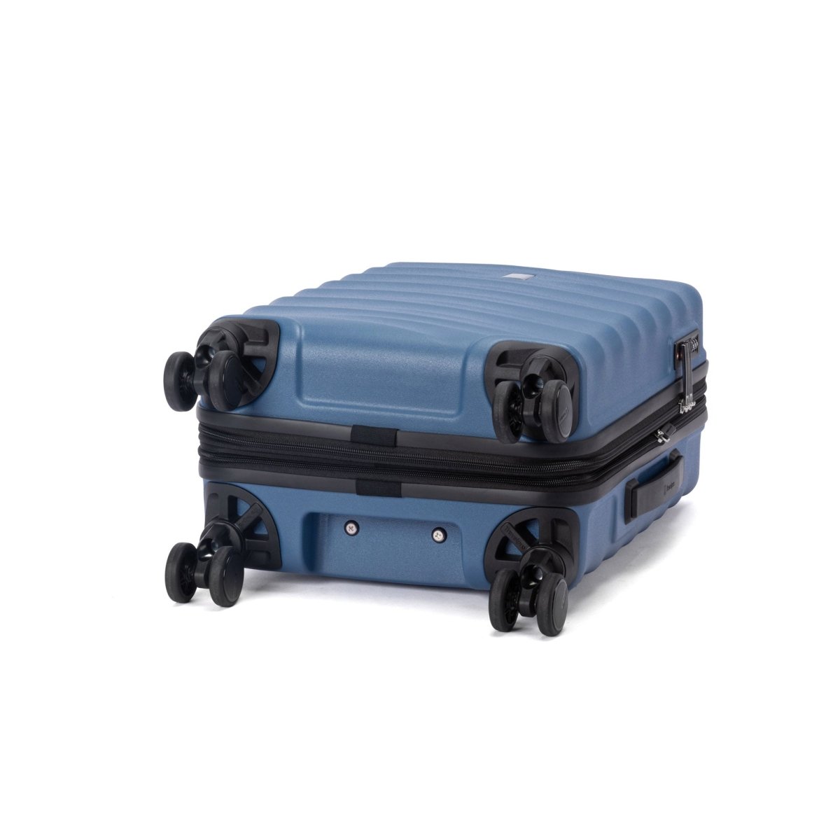 The Travelpro Maxlite Air V2 blue hardside spinner carry-on with four double wheels lies on its back.