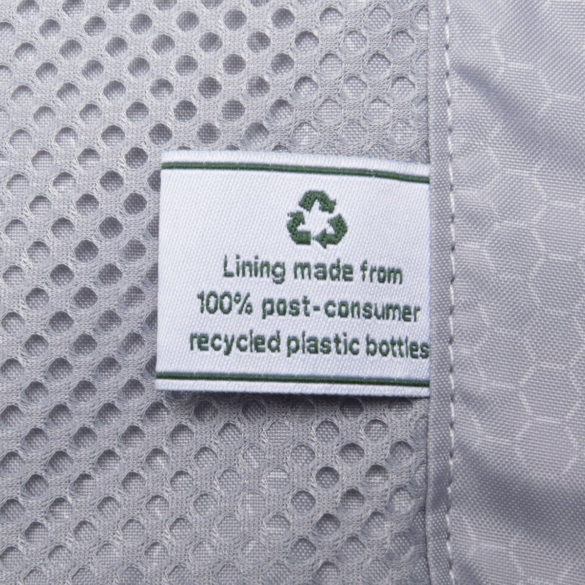 The Travelpro® Maxlite® Air V2 spinner's tag reads, “Lining made from 100% recycled plastic bottles.”.