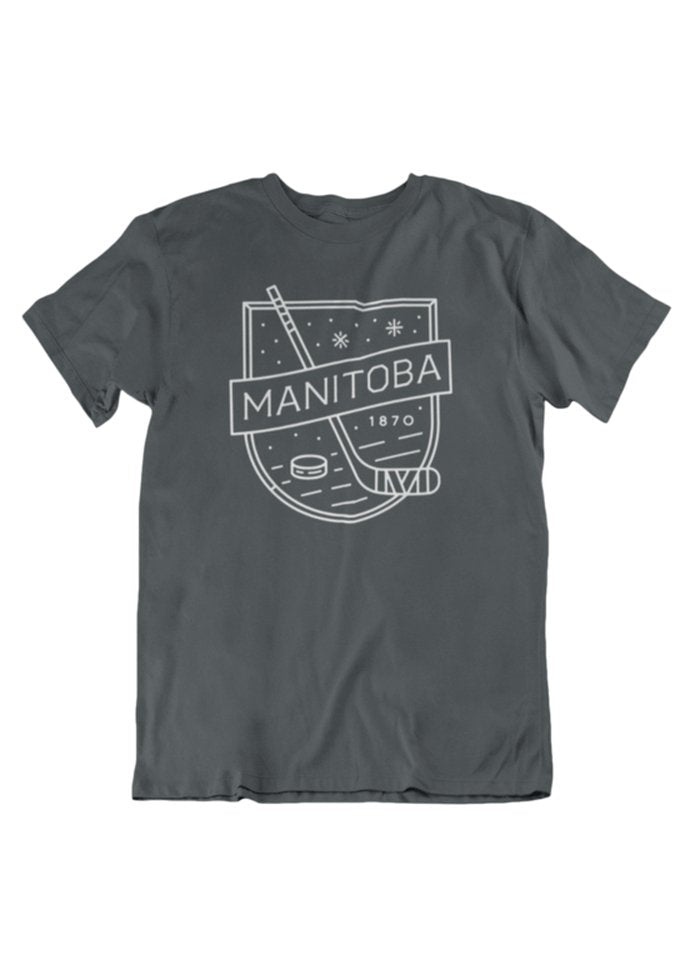 Charcoal T-shirt designed for the puck lover's wardrobe, featuring a hockey stick, puck, and the text "MANITOBA 1870" in white—an essential addition for any MB Hockey tee collection from We Heart Winnipeg. Introducing the We Heart Winnipeg MB Hockey T-Shirt.