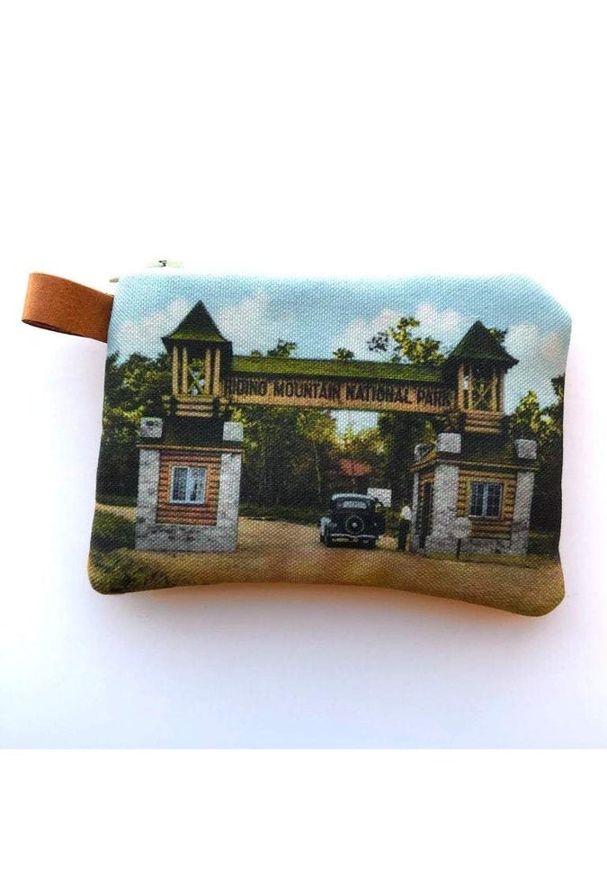 The Winnipeg North of Fargo Coin Purses boast a vintage-style design with an interlined interior, showcasing an image of a national park entrance with two towers and an old car, making them ideal for storing earbuds or small items.