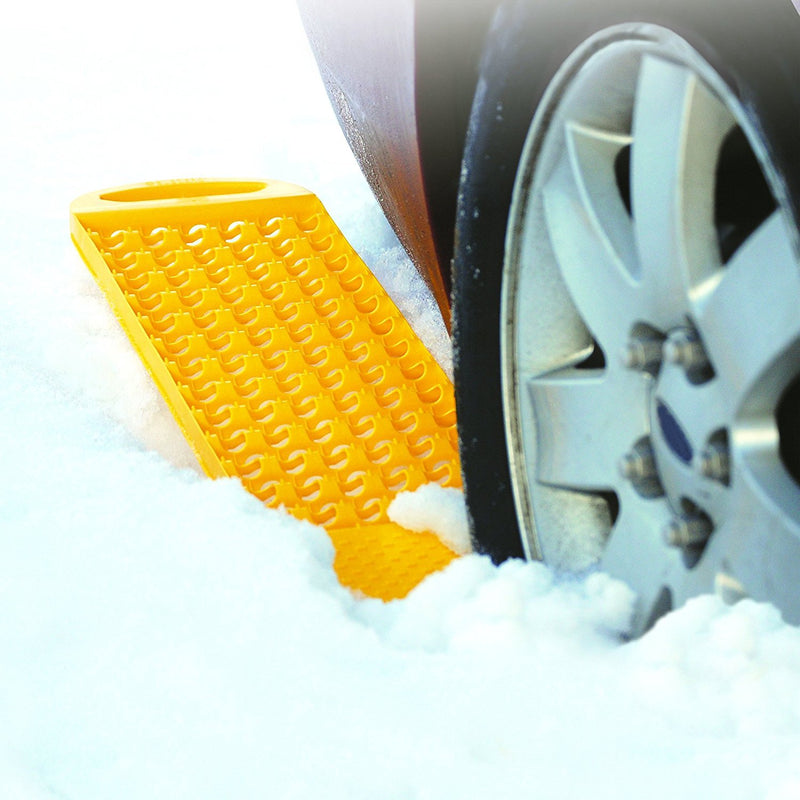 Image showing closeup of tire in thick snow with product molded in yellow sticking out from rear of tire.