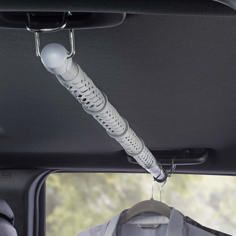 Image showing the product molded in grey plastic installed inside a vehicle with clothes on hangers to the right.